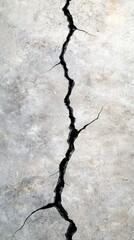 A crack in a concrete wall with a black and white background