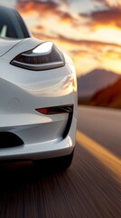 Fototapeta premium A white sports car driving down a road at sunset