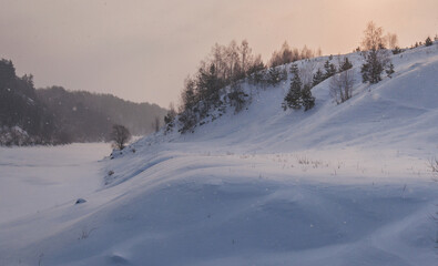 Walk over the river Sluch in the snowfall.