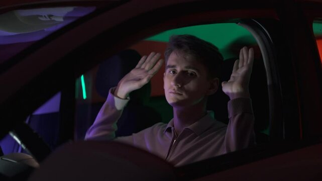 Stopped young criminal in car raises hands in surrender to police