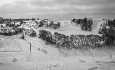 Fototapeta premium Walk over the river Sluch in the snowfall.