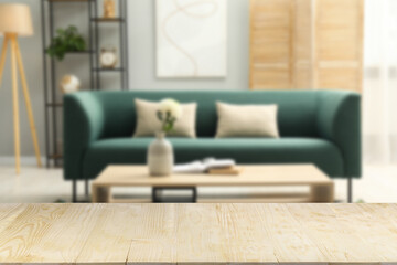 Empty wooden table in beautiful living room. Space for design