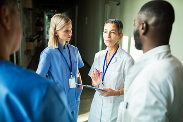 Medical professionals discussing in hospital hallway