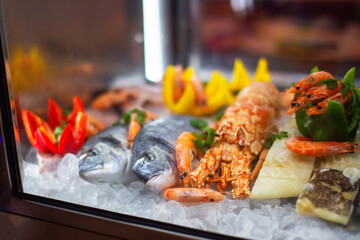 Seafood on ice in the refrigerator of the restaurant. Shallow depth of field