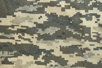 Texture of Dark green pixel camouflage military uniform textile cloth with folds