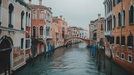 Fototapeta premium Venetian Canal Scene With Old Buildings and Bridge