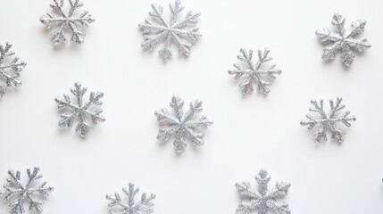 Silver glitter snowflakes arranged in a radial pattern for winter decoration