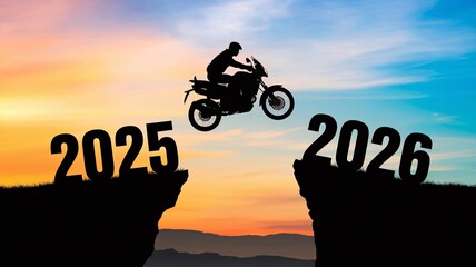 A motorcycle rider performs a daring jump between two cliffs marked 2025 and 2026 during a vibrant sunset. The sky is filled with shades of orange and blue, enhancing the thrill.