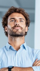 Fototapeta premium A man with his arms crossed looking up at the sky