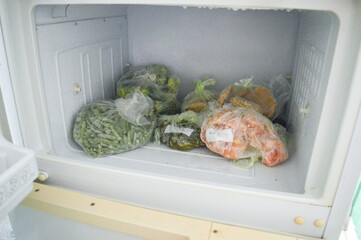 organized freezer filled with various frozen vegetables plastic bags food preservation tips storage long-term freshness healthy meal prep sustainability waste reduction kitchen organization ideas