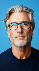 Obraz premium A man with grey hair and blue eyes wearing glasses