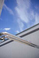Shiny galvanized heating pipes with clear sky