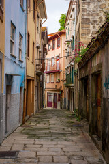Charming Narrow Alley in Historic Old Town with Colorful Houses and Lush Vegetation on a Quiet Summer Day in Porto, Portugal
