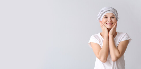 Woman after chemotherapy on light background