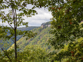 Majestic cliffs crown the steep mountainside along the Endless Wall Trail in New River Gorge National Park, West Virginia, framed by green foliage