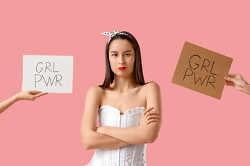 Portrait of young pin-up woman with GRL PWR signs on pink background. Women's History Month