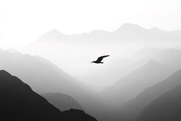 Naklejka premium Silhouettes of mountains in the mist and bird flying