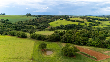 green aerial landscape with hills and trees