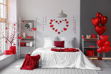 Interior of festive bedroom decorated with hearts for Valentine's Day celebration