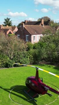 helicopter parked grass luxurious castle property england motion adds touch to scene slow front forward aerial shot luxury country house scenic view aviation 