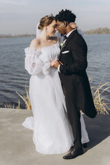 Interracial couple getting married near a lake