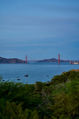 Panoramic view of the large metal red bridge across the bay