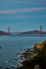 Panoramic view of the large metal red bridge across the bay