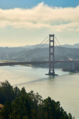 Panoramic view of the large metal red bridge across the bay