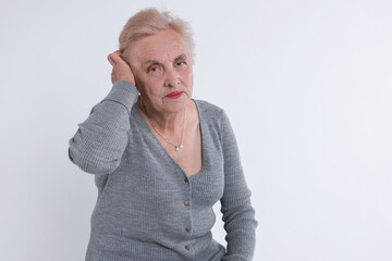 Portrait of senior woman on white background. Space for text