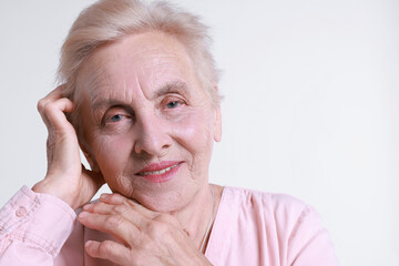 Portrait of senior woman on white background. Space for text