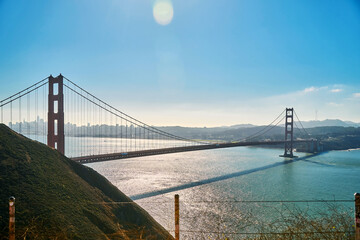 Panoramic view of the large metal red bridge across the bay
