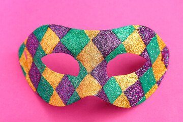 Shiny carnival mask for Mardi Gras celebration on pink background © Pixel-Shot