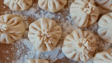 Close-up of homemade Georgian dumplings on a floured surface