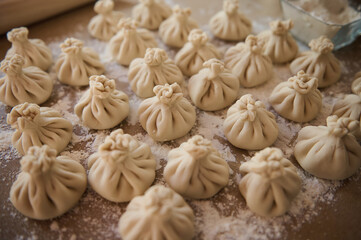 Close-up of freshly prepared homemade Georgian-style dumplings on dusted surface