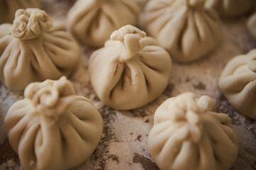 Close-up of Handmade Georgian Khinkali Dumplings on a Floured Surface