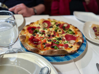 Tasty pepperoni pizza with basil on grey table