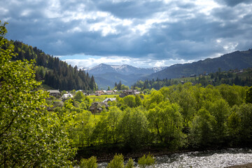 Beautifull ukrainian village Verhovina in spring with mountain with snow.