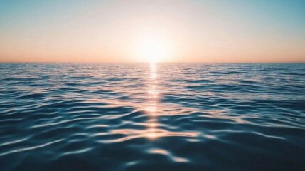 Obraz premium Serene Sunrise Over Calm Ocean Waters with Gentle Ripples Reflecting the Soft Light of Dawn Illuminating the Horizon in Tranquil Beauty