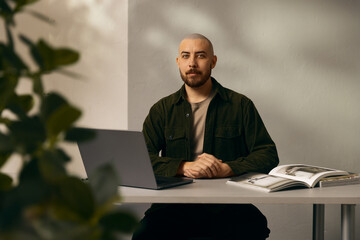 A man working on a laptop at a desk.