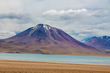 Lakes in the desert Atacama landscape in Chile. The view point to the green crystal lakes, volcanoes and mountains. Lookout Mirador Laguna Miniques and Miscanti in San Pedro de Atacama desert