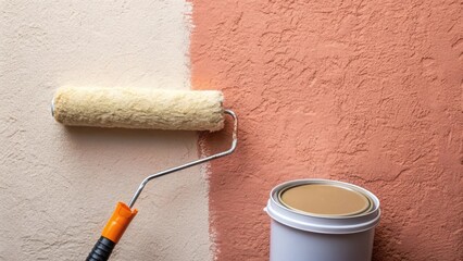Obraz premium Close proximity to a wall revealing the saturated primed surface catching the light at various angles accompanied by a fluffy paint roller resting beside a partially od primer can.