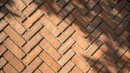 A woven effect created by the placement of bricks in a herringbone pattern highlighting the interplay of shapes and shadows.