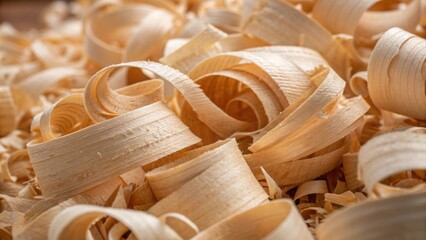 A detailed view of thick layered wood shavings some larger and fluffy others finer and more delicate all intertwined to create a visually striking composition of organic materials.