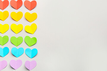 Colorful paper hearts on grey background. Valentine's Day celebration