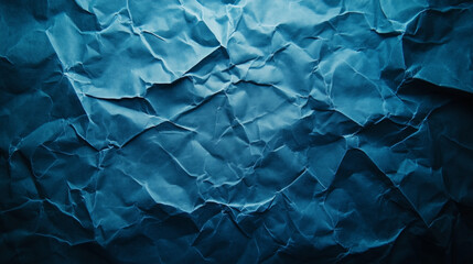Obraz premium Crumpled blue paper texture with intricate shadows and folds creating a dynamic visual effect