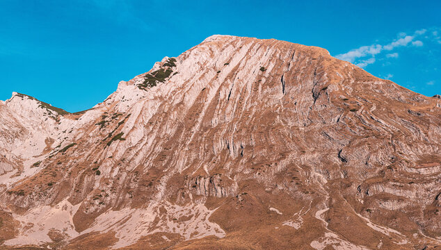 Majestic mountain peak Prutas in Durmitor national park dominating the landscape under a vibrant blue sky, travel destinations in Montenegro