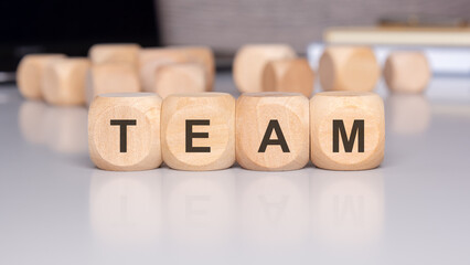 The concept of team collaboration depicted with wooden blocks represents unity and teamwork