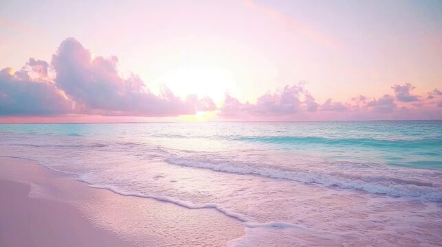 Serene pink sunrise over calm ocean waves on a sandy beach.