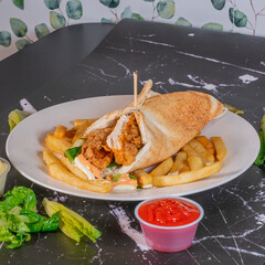 Crispy Chicken Wrap with French Fries and Dipping Sauces on Marble Table

