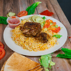 Slow-Cooked Lamb over Biryani Rice with Fresh Vegetables and Sauce

